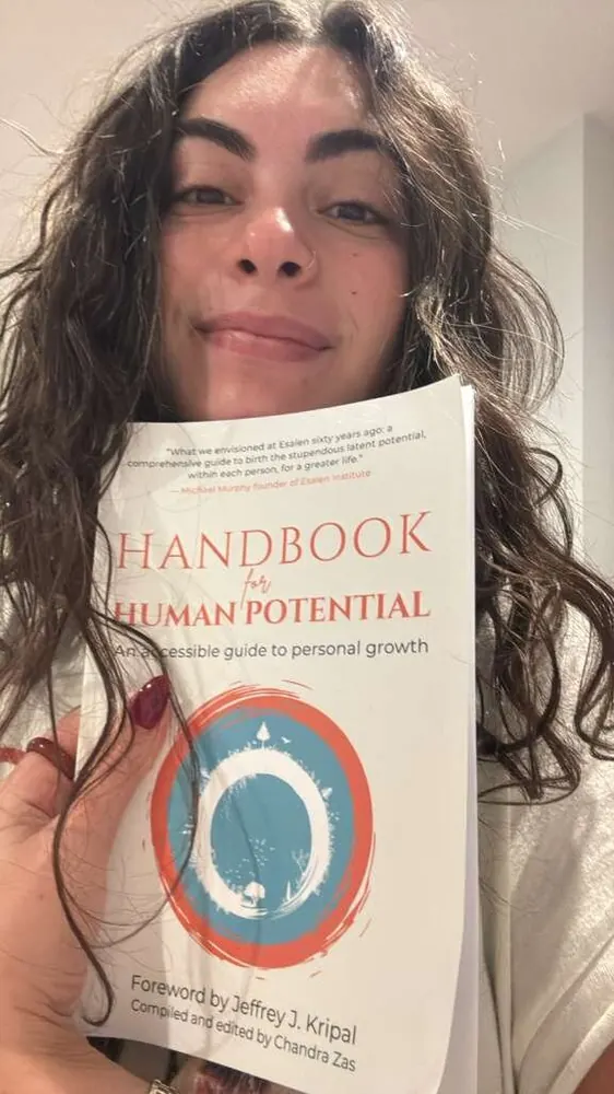 Reader holding Handbook for Human Potential — reader photo 1