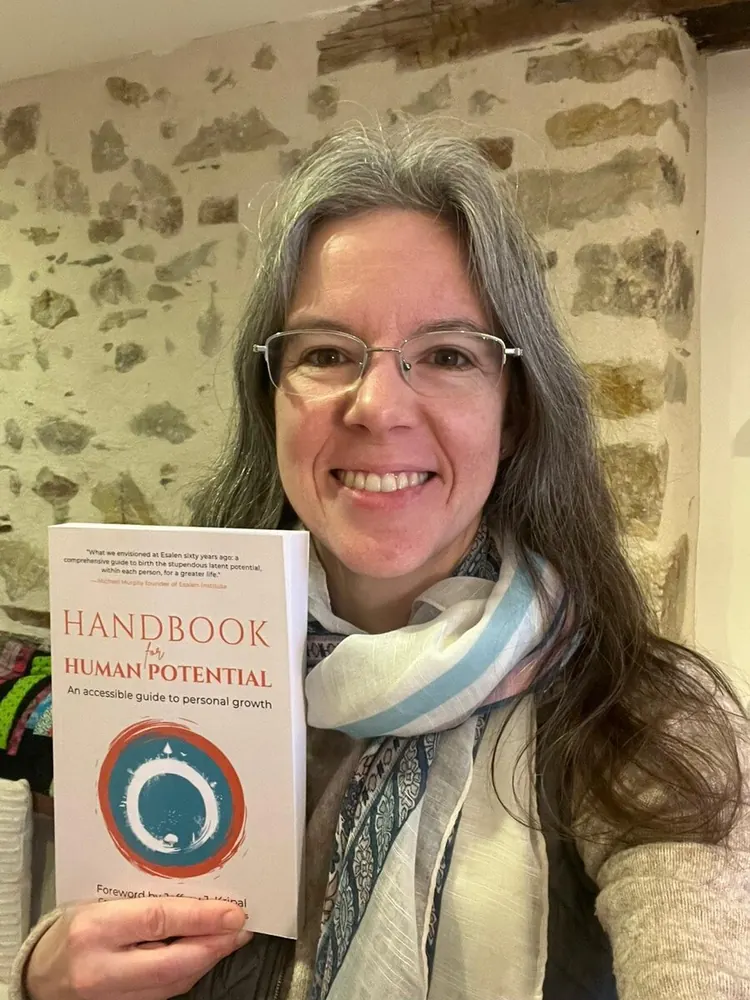 Reader holding Handbook for Human Potential — reader photo 2