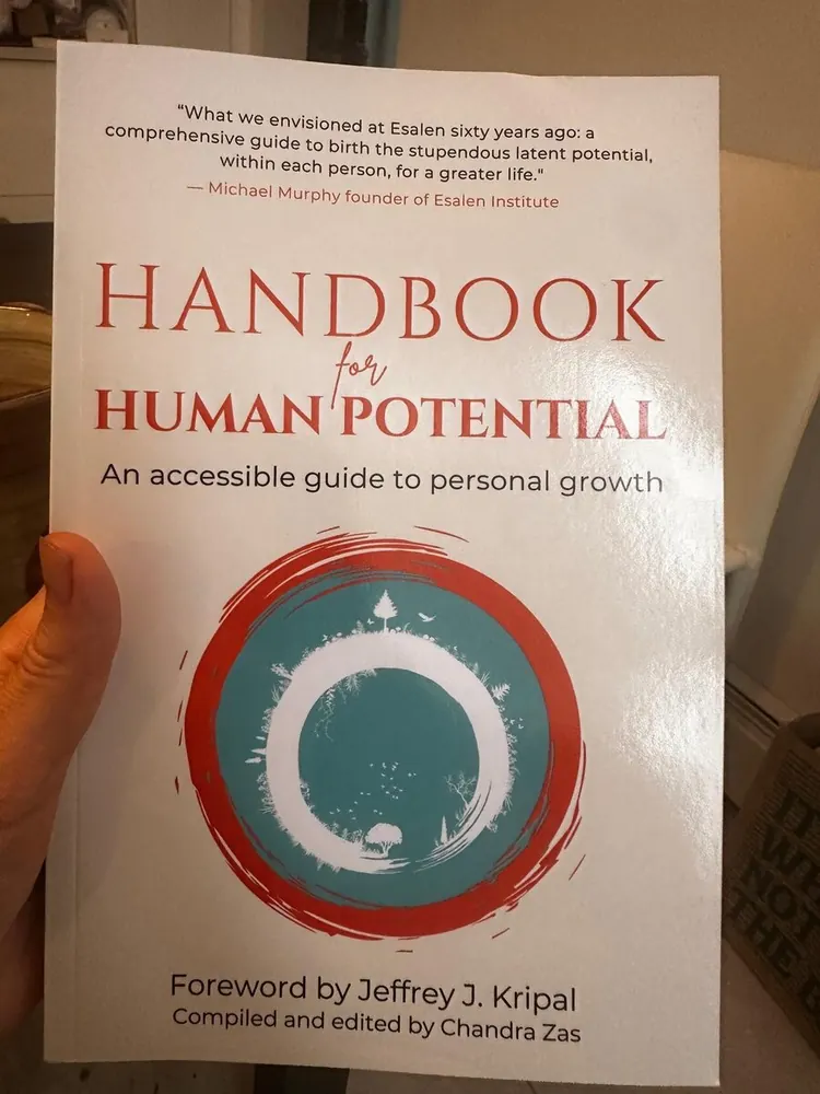 Reader holding Handbook for Human Potential — reader photo 4